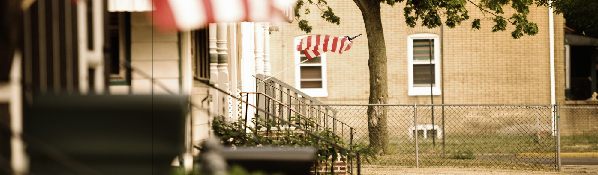 A small town street with American flags displayed.